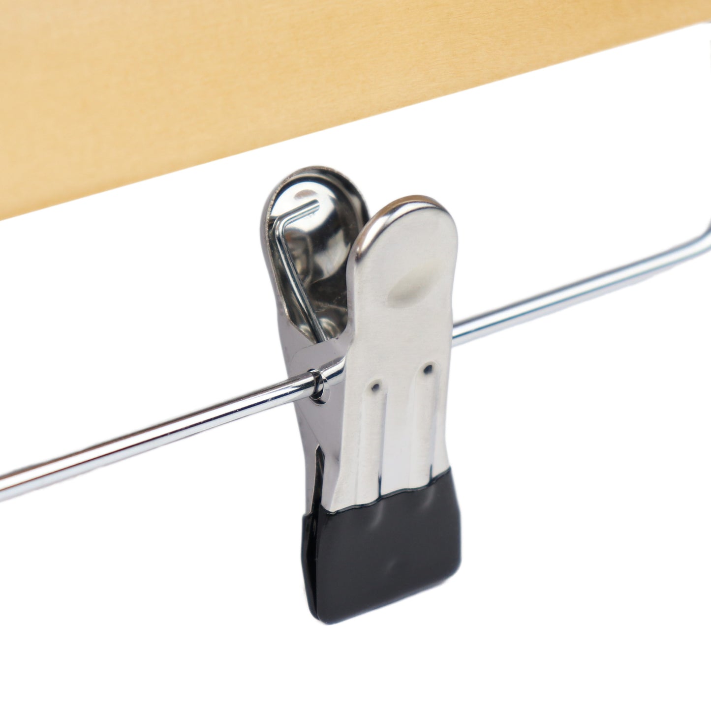 A close-up image of a metallic binder clip securing a stack of beige paper. The clip is attached to a shiny wire-like object and has black gripping pads on its ends, reminiscent of the premium wood used in **Hangers of London Natural Wooden Clip Bottom Hanger 35cm** for wardrobe organization.