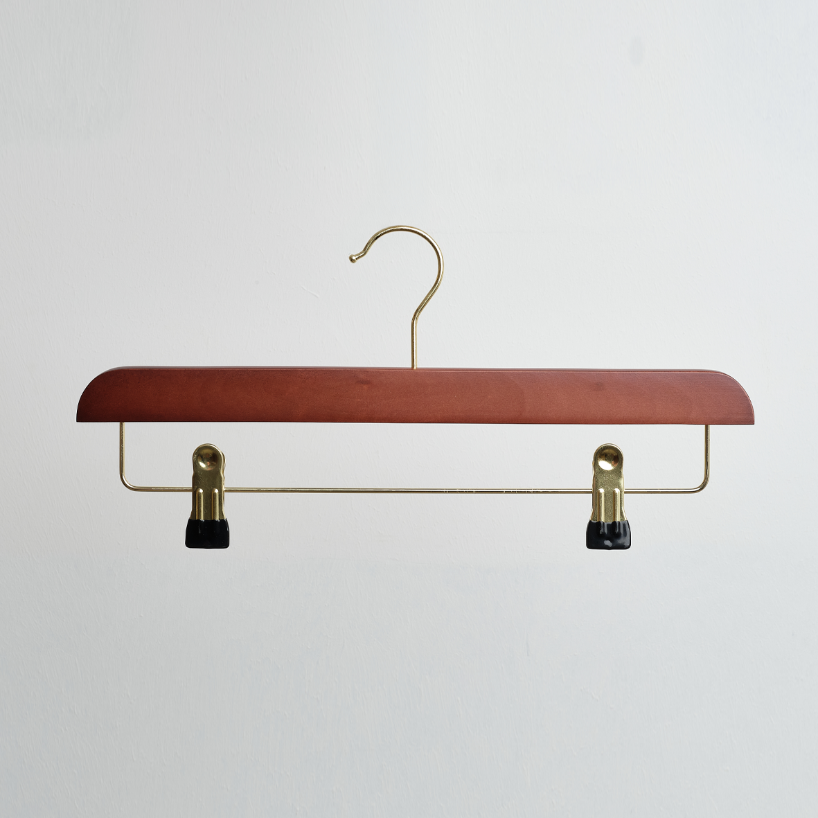 The Hangers of London Dark Wooden 35cm Clip Hanger with gold hardware and two black plastic clips is displayed against a plain white background.