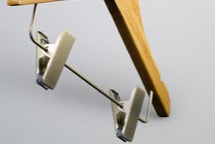 A Bamboo Wood Sustainable Children's Top Clip Hanger 26cm by Hangers of London is shown against a plain, light background. The eco-friendly hanger is angled slightly and designed to hold clothing items such as skirts or pants.
