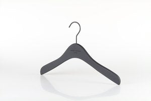 A single black Wooden Rubber Soft Touch Kids Top Harvey Nichols 32cm hanger from Hangers of London with a curved design is shown against a plain white background. The hanger has a metal hook at the top and a smooth, minimalist appearance.