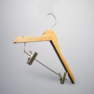 A Bamboo Wood Sustainable Top Clip Hanger 42cm from Hangers of London, with a metal hook and integrated clips for hanging pants or skirts, set against a light gray background. The design is simple and functional, making it a perfect eco-friendly clothing organizer for various garments.