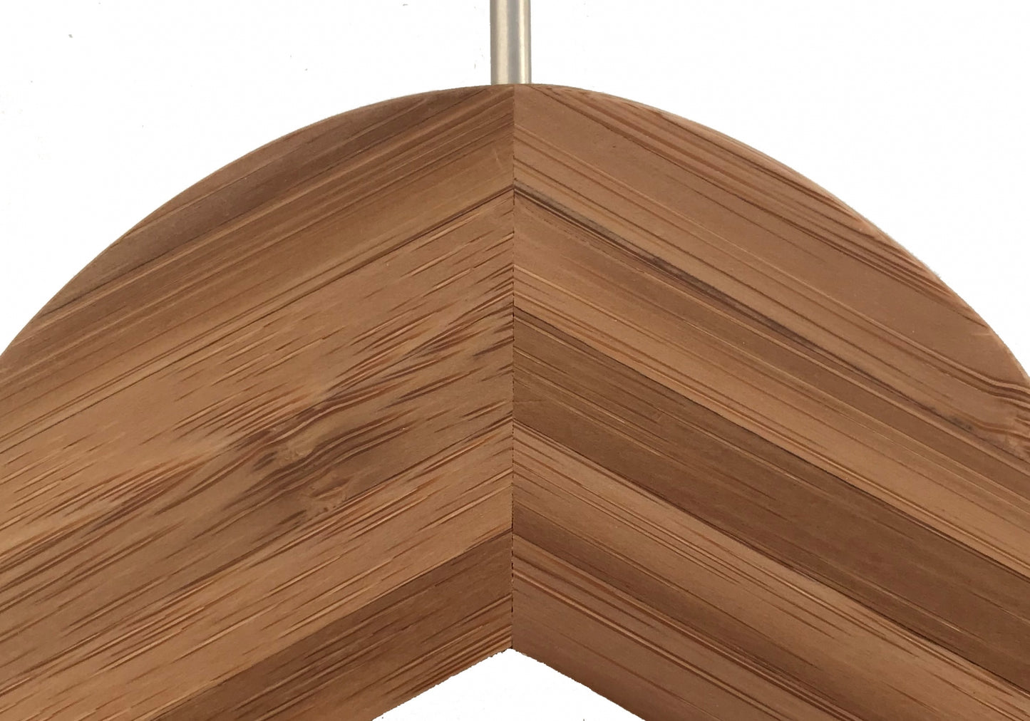 A close-up of the corner of a wooden picture frame displaying the intricate grain pattern and angled joints. The wood has a warm, natural color, similar to that found in Hangers of London's Bamboo Wood Sustainable Top Jacket Hanger 42cm, and the frame is mitered at a precise 45-degree angle.