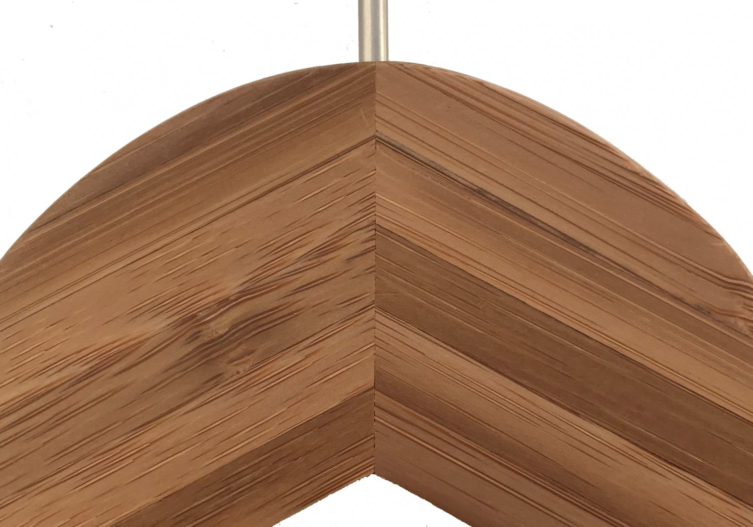 Close-up of the corner of a bamboo wood frame. The pieces are joined at a diagonal angle, creating a chevron pattern with prominent wood grain and texture visible. This eco-friendly Hangers of London Bamboo Wood Sustainable Top Hanger with Notch 42cm contrasts beautifully against the plain white background, showcasing its sustainable design.
