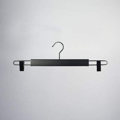 A Hangers of London Black Wooden Clip Bottom Hanger 37cm is centered against a plain, light-colored background. The hanger features a curved hook at the top that allows for 360 degree rotation, a straight bar in the middle, and metal clip extensions on either side to hold clothing securely.