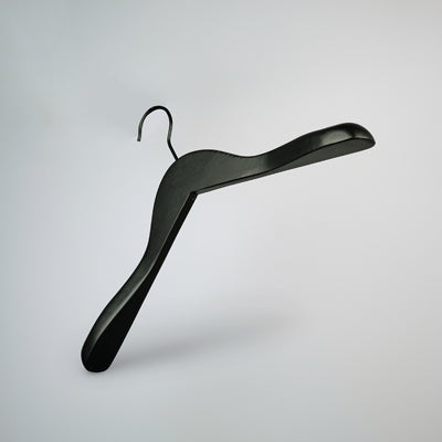 A stylish, black wooden jacket top coat hanger with a hook at the top is suspended against a white background. The Black Wooden Jacket Top Coat Hanger 38cm by Hangers of London features broad, angled shoulders designed to support heavier garments without slipping off, showcasing high-quality craftsmanship.