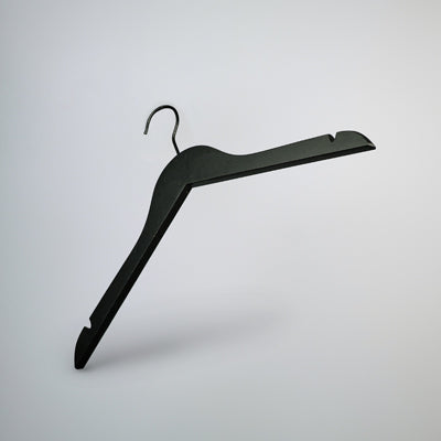 A Black Wooden Top Clothes Hanger with Notch 44cm by Hangers of London is suspended against a minimalist, light gray background. This top-notch clothing storage solution features a standard hook at the top and angled arms with shoulder notches for securing garments.