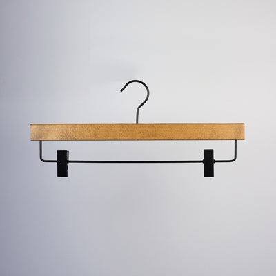 A Dark Wood Sustainable Bottom Trouser Skirt Hanger With Clips 37cm from Hangers of London, featuring a metal hook and bar. The hanger includes two adjustable black plastic clips on either end of the metal bar for securing clothing items. The background is plain white.