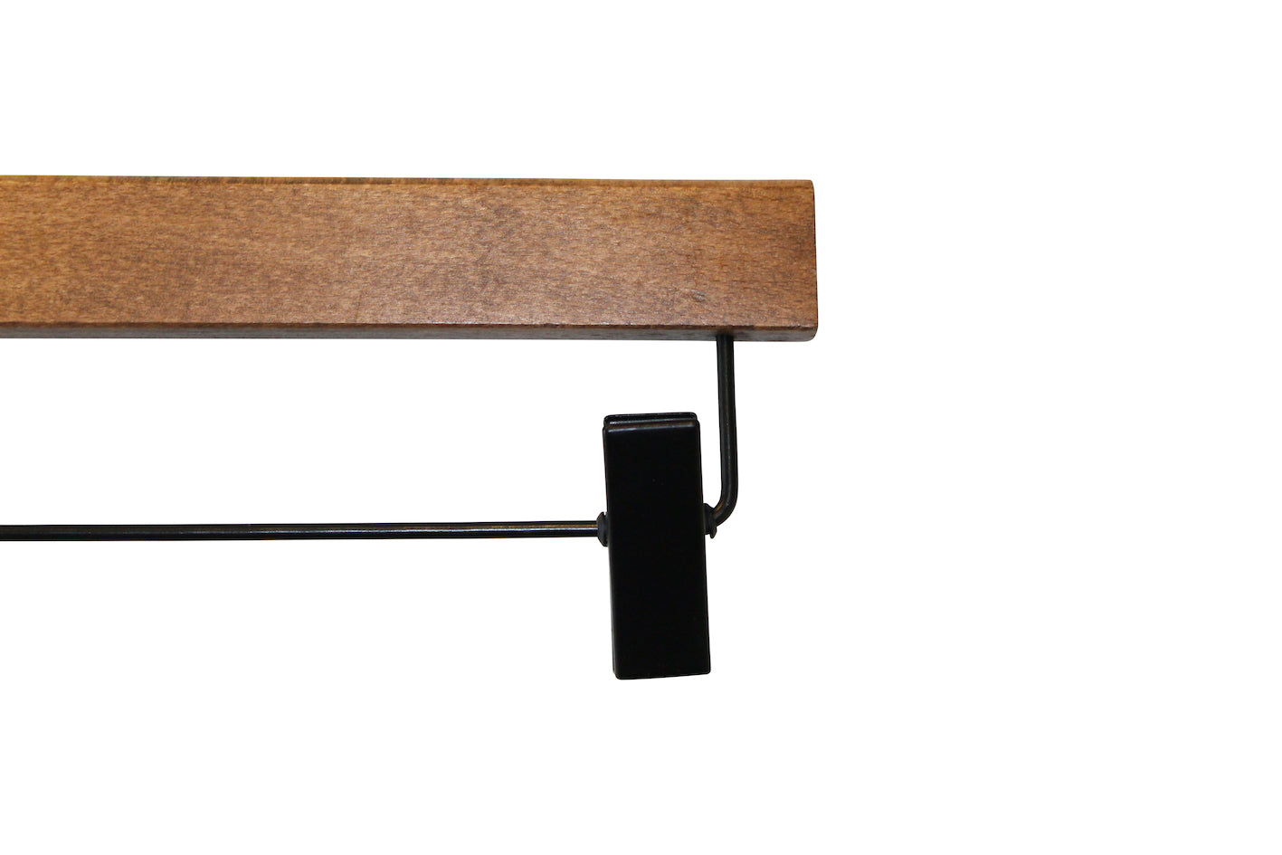 An image of a black metal clip attached to an FSC certified wooden hanger bar. The clip, designed to hold items such as pants or skirts, is aligned perpendicular to the sustainable dark wood hanger from Hangers of London. This specific product is the Dark Wood Sustainable Bottom Trouser Skirt Hanger With Clips 37cm. The background is plain white.