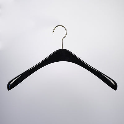A Hangers of London Black Wooden Top Coat Premium Hanger 42cm with a metal hook is suspended against a plain white background. Crafted from high-quality black wood, the hanger features broad, rounded ends to support clothing and a curved design for jackets or coats.