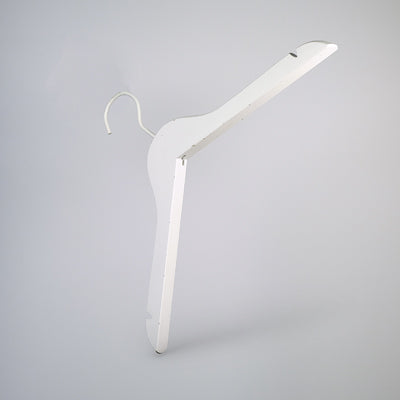 A White Wooden Clothes Hanger with Notch 44cm by Hangers of London with a simple, minimalist design is shown against a plain grey background. The high-quality clothes hanger has a hook at the top for hanging on a rod and is slightly angled to display its form clearly, perfect for closet organization.