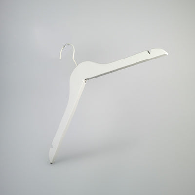 A Hangers of London White Wooden Clothes Hanger with Notch 38cm, positioned against a plain gray background, exemplifies closet organization. The hanger features notches on each shoulder for securing straps.