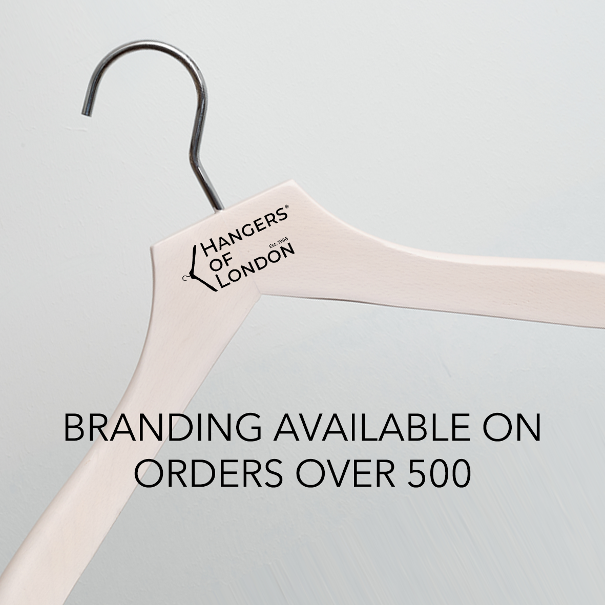 A Dark Wooden 44cm Top Hanger With Notches And Gold Hardware by Hangers of London, displayed against a light background. Text reads: “Branding available on orders over 500.”.