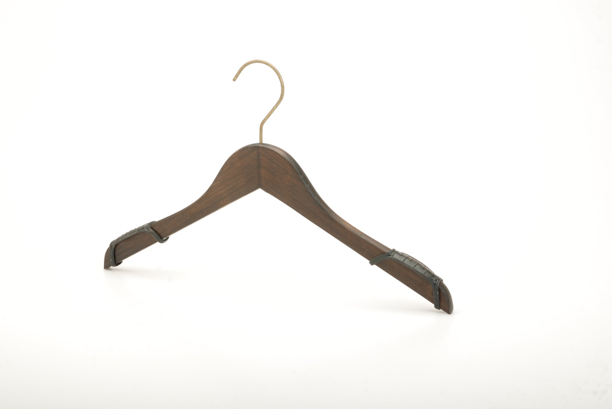 A wooden coat hanger with a brass hook is shown against a plain white background. The Hangers of London Wooden Antique finish Top 38cm, featuring an antique finish, has curved ends to support the shoulders of garments and black non-slip grips on the sides, adding a touch of vintage charm.