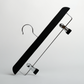 A Hangers of London Black Wooden 35cm Clip Hanger, featuring two adjustable metal clips in a black and silver design, is positioned diagonally against a plain white background.