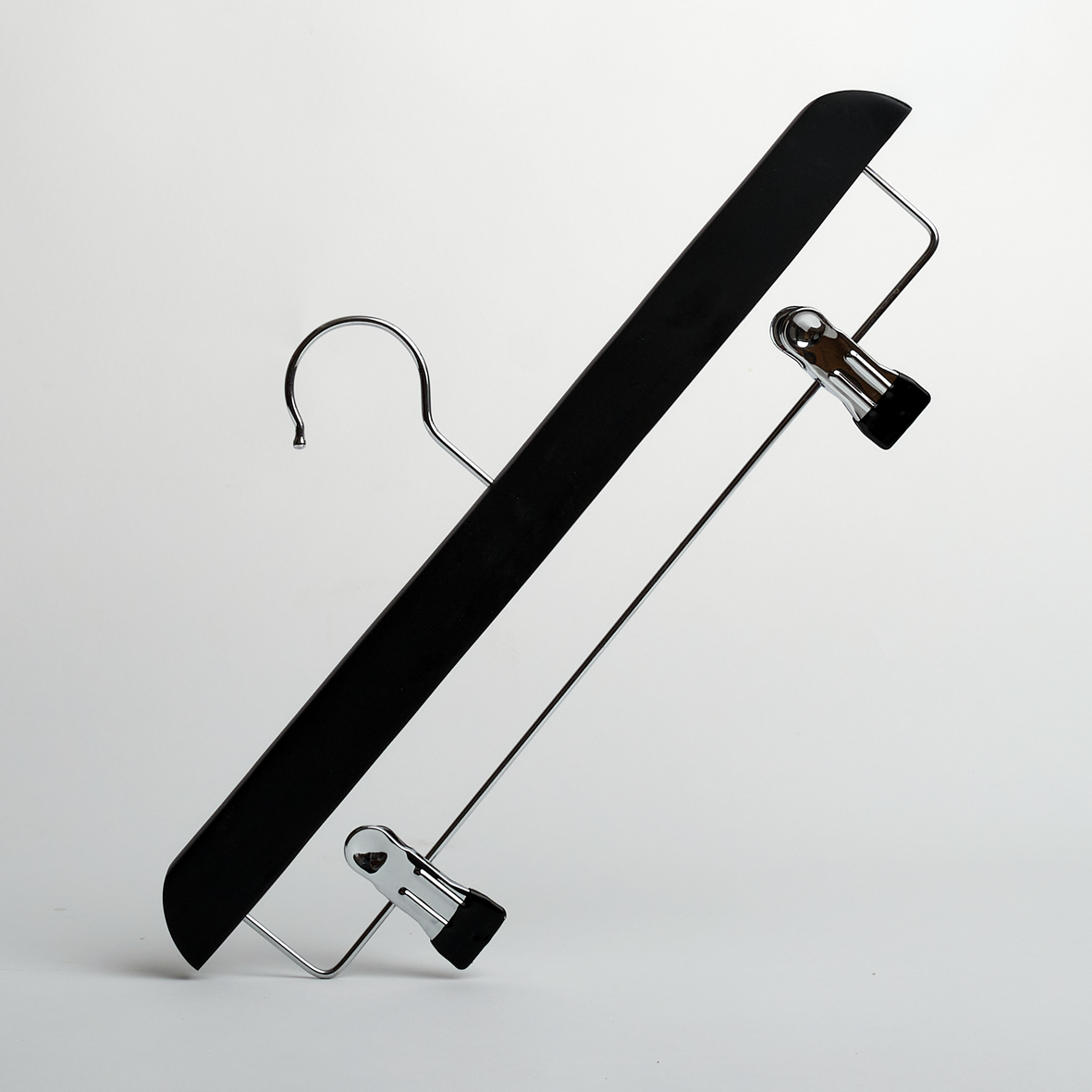 A Hangers of London Black Wooden 35cm Clip Hanger, featuring two adjustable metal clips in a black and silver design, is positioned diagonally against a plain white background.