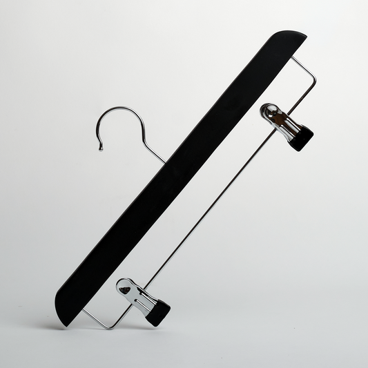 A Hangers of London Black Wooden 35cm Clip Hanger, featuring two adjustable metal clips in a black and silver design, is positioned diagonally against a plain white background.