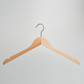 A Natural Wooden 44cm Top Hanger With Notches from Hangers of London is suspended against a light gray background.
