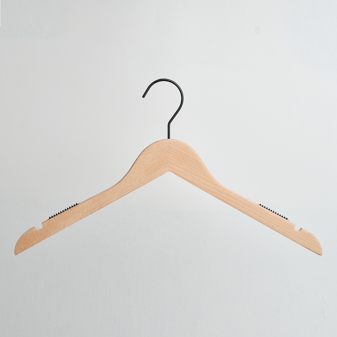 A Hangers of London Luxury FSC Certified Beech Wooden 42cm Top Hanger with a black metal hook and non-slip grips is hanging against a white background.