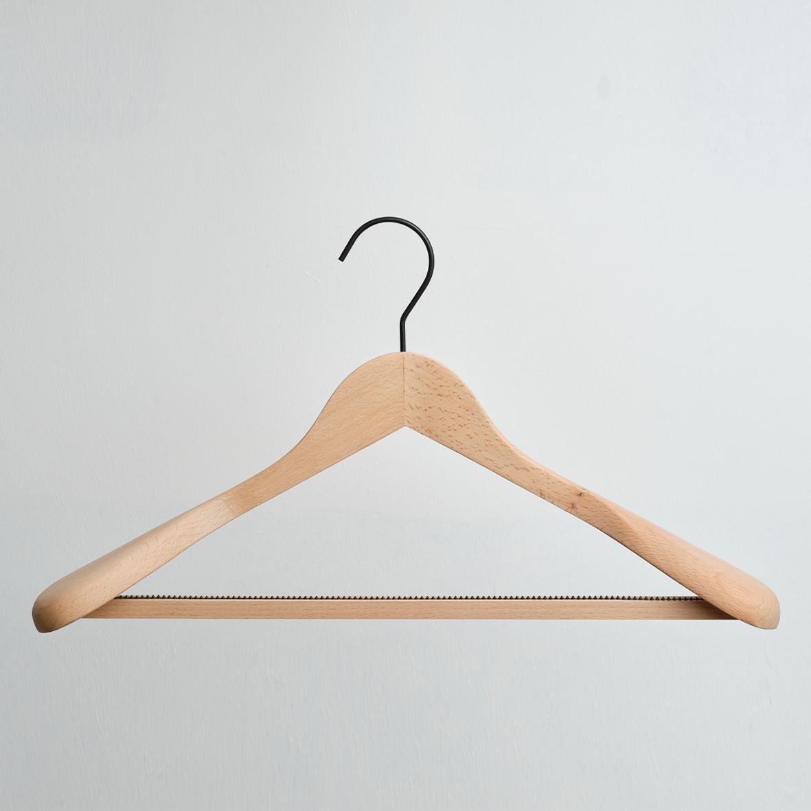 A Luxury FSC Certified Beech Wooden Jacket Hanger With Trouser Bar by Hangers of London is hanging against a white background.