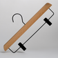 The “Luxury FSC Certified Beech Wooden 35cm Clip Hanger” by Hangers of London features a smooth beech wood design, a black metal hook, and two black adjustable clips for securing pants or skirts. It is displayed against a plain white background.