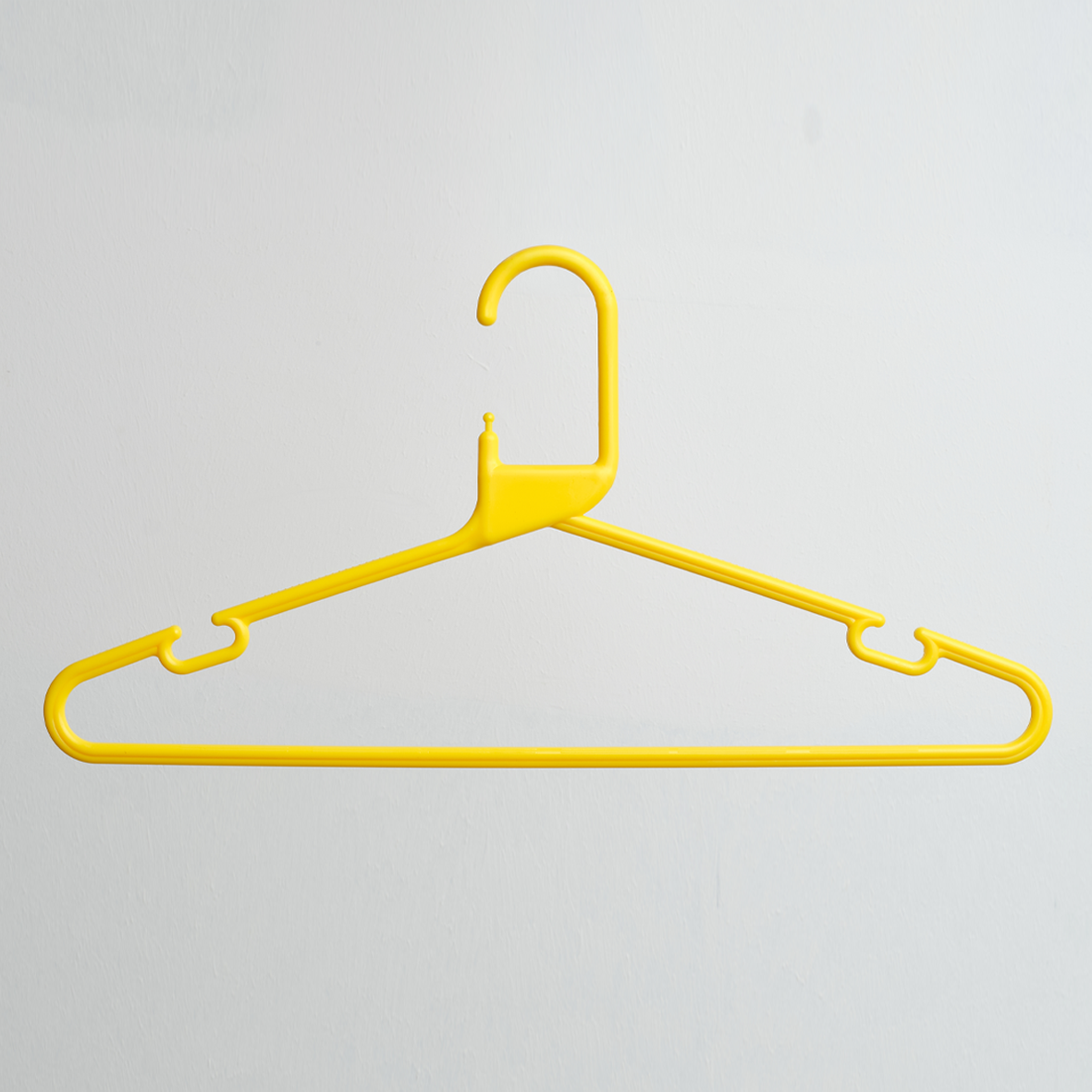 A Heavy Duty Economy Yellow Multi Purpose Rainbow Hanger from Hangers of London is displayed against a plain white background.