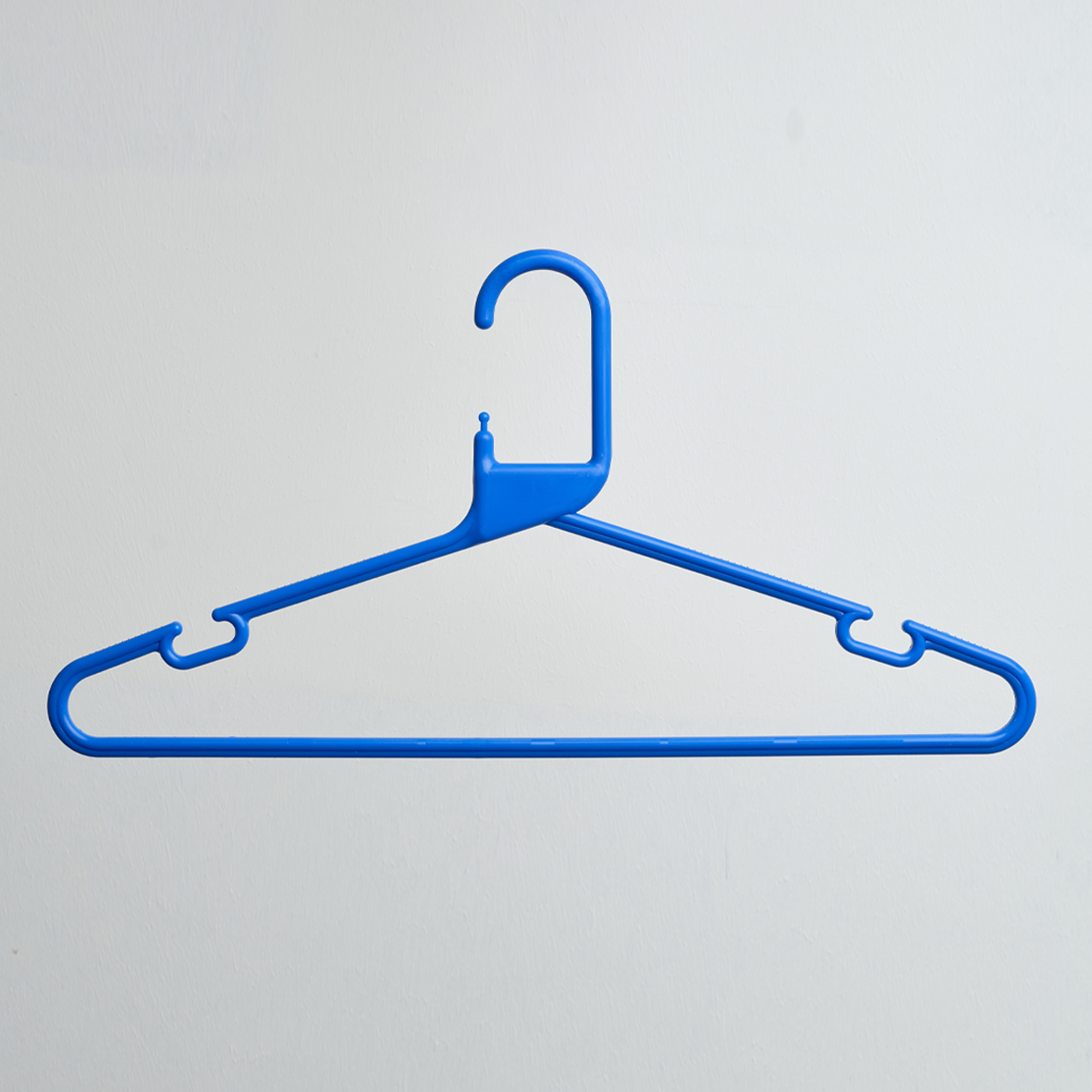 A single Heavy Duty Economy Blue Multi Purpose Rainbow Hanger by Hangers of London, featuring a hook at the top, is displayed against a plain white background.