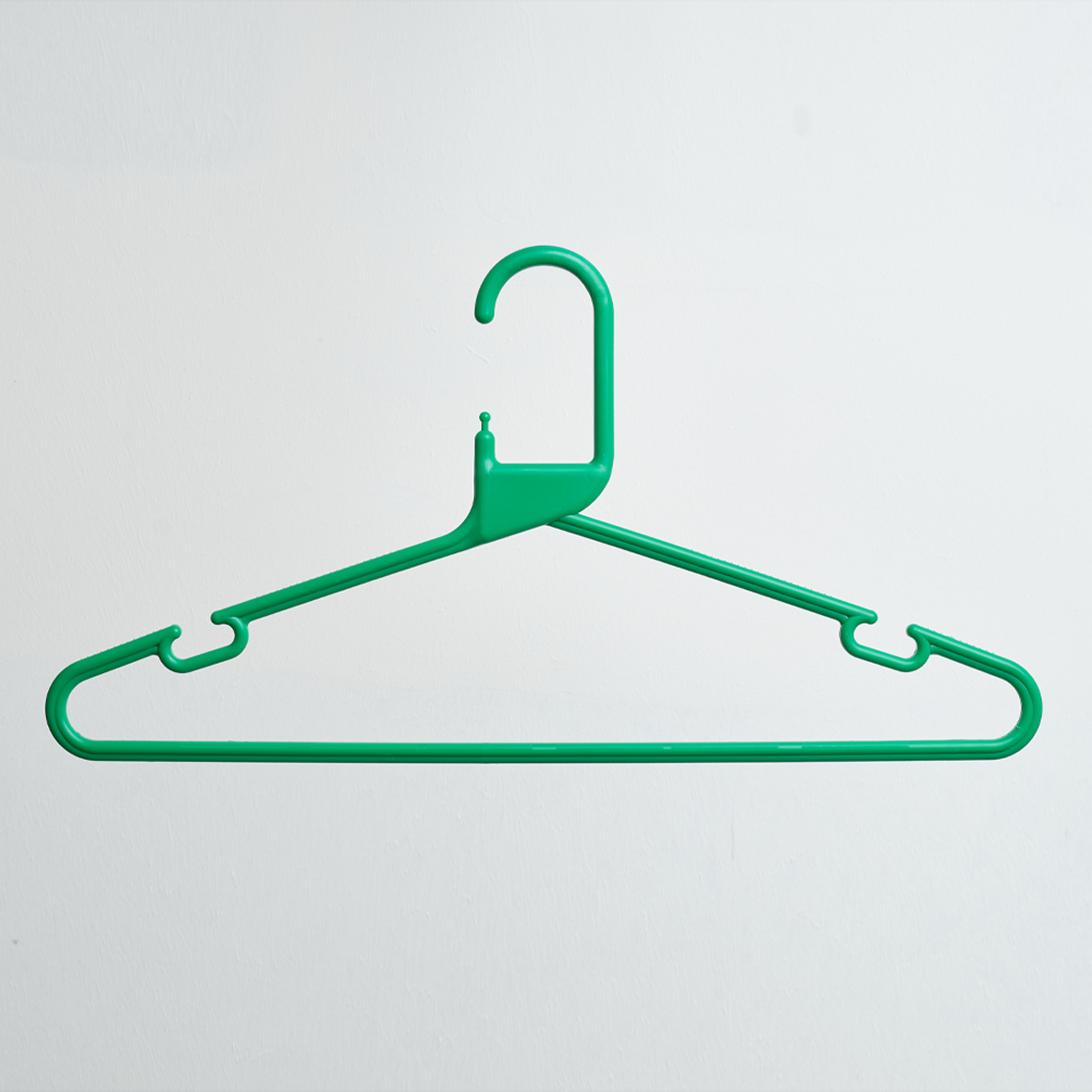 A Heavy Duty Economy Green Multi Purpose Rainbow Hanger from Hangers of London, part of a 300-pack set, hangs against a plain white background.