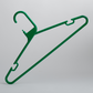 A Heavy Duty Economy Green Multi Purpose Rainbow Hanger by Hangers of London stands upright against a plain gray background. This plastic hanger features hooks for straps and a curved hook at the top for hanging.