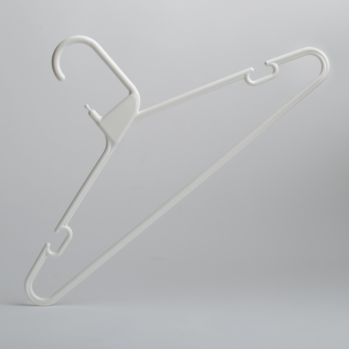 The Heavy Duty Economy White Multi Purpose Rainbow Hanger by Hangers of London is shown against a plain light gray background, featuring a durable white plastic design with a hook and notches for straps.