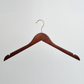 A pack of 100 Dark Wooden 44cm Top Hangers with notches and gold hardware from Hangers of London is displayed against a plain white background.
