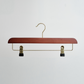 The Hangers of London Dark Wooden 35cm Clip Hanger with gold hardware and two black plastic clips is displayed against a plain white background.