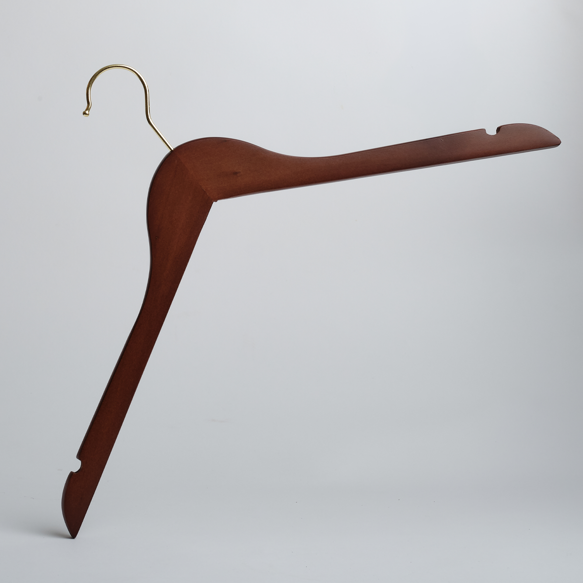 A Hangers of London Dark Wooden 44cm Top Hanger with Notches and Gold Hardware, standing upright on one angled arm against a plain white background.