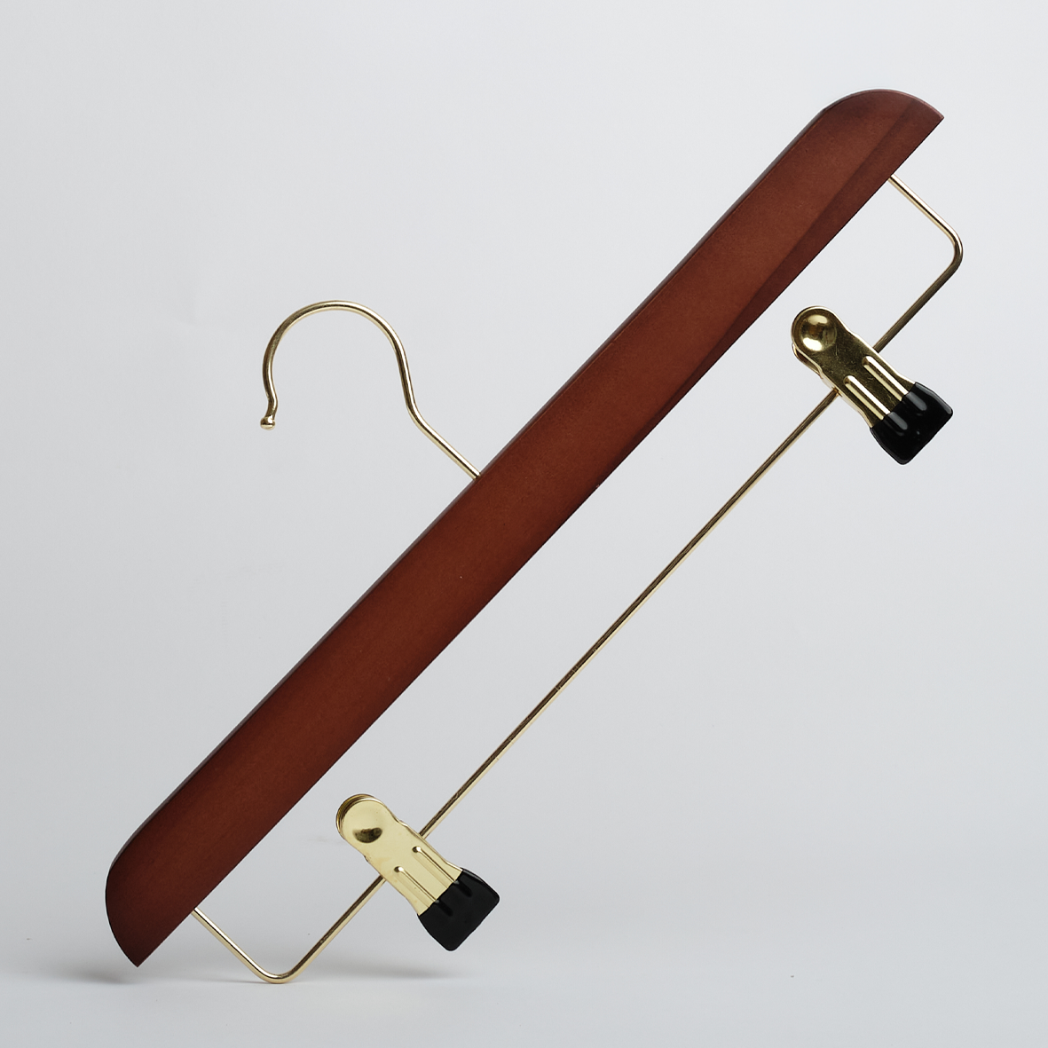 The Hangers of London Dark Wooden 35cm Clip Hanger With Gold Hardware (Pack of 100) features a rich wooden body with a gold metal hook and bar, complemented by two black and gold clips for hanging pants or skirts, shown against a plain white background.