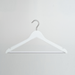 A White Wooden 44cm Top Hanger With Non Slip Trouser Bar by Hangers of London is hanging against a plain light gray background.