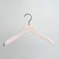 A Luxury Whitewashed FSC Certified Beech Wooden 41cm Jacket Hanger by Hangers of London, featuring a silver hook, is hanging against a light gray background.