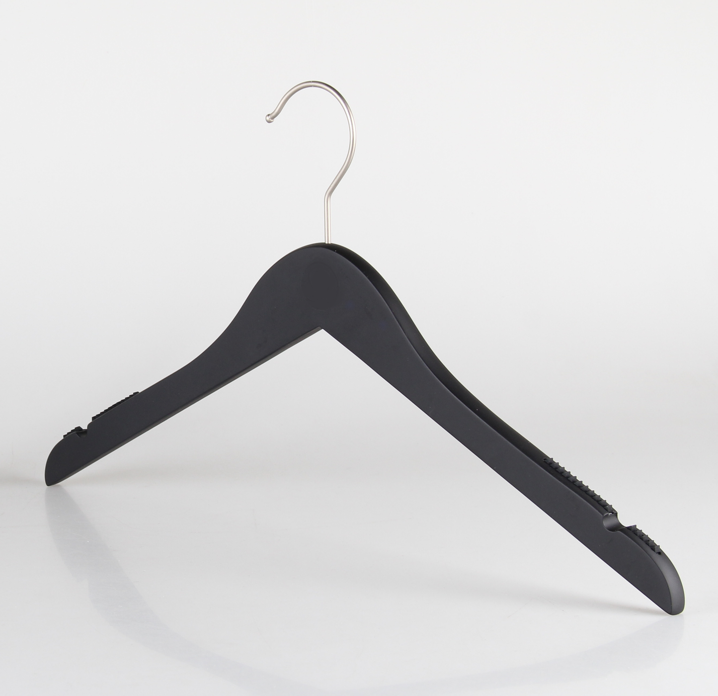 A Wooden Rubber Soft Touch Black Kids Top (30cm) by Hangers of London is set against a plain white background. The hanger, designed for children's clothes, has notches on the shoulders for securing straps and a slightly contoured shape for holding garments.