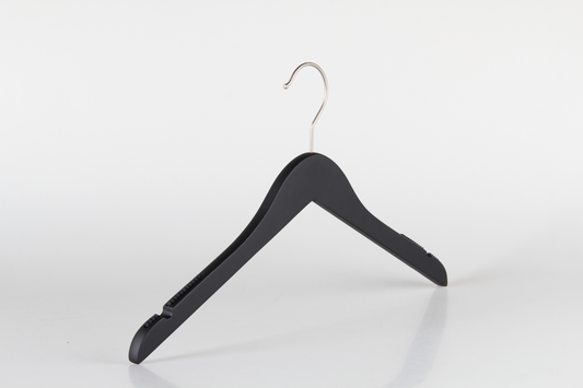 A Hangers of London Wooden Rubber Soft Touch Black Kids Top (30cm) with a shiny silver hook is positioned against a plain white background. The hanger features indents on the shoulders for securing garments with straps. The simple design and reflective surface create a minimalistic and modern appearance, ideal for children's clothes.