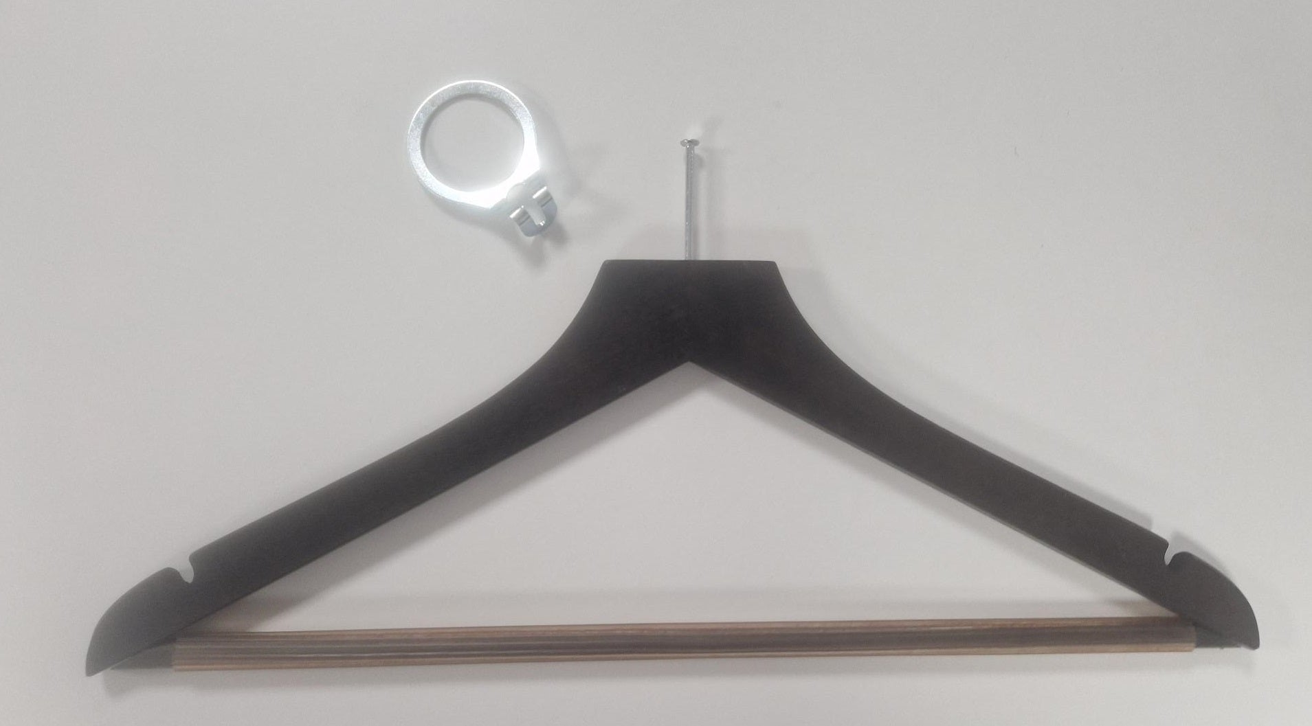 A Hangers of London Wooden Hotel Anti Theft Jacket (Dark Brown) 44cm is lying against a white background. Above the hanger is a metal ring-like object with a small bracket attached, emphasizing security priority for guests.